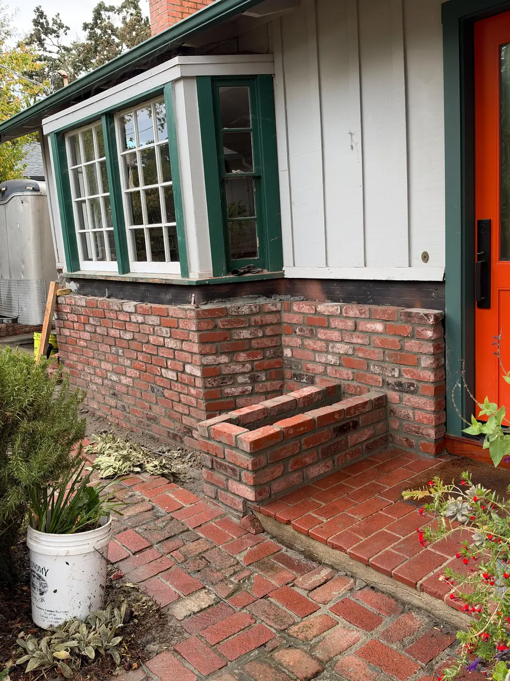 Red brick wall and steps at a home entrance