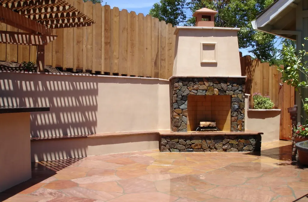Outdoor stone fireplace with flagstone patio