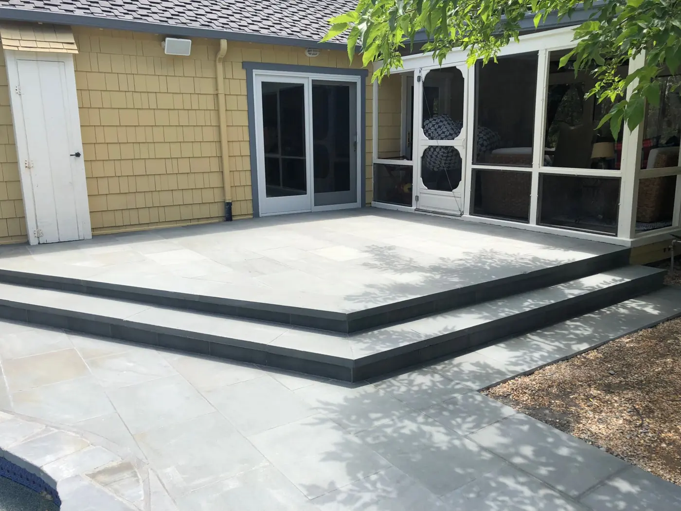 Stone steps leading to a concrete patio