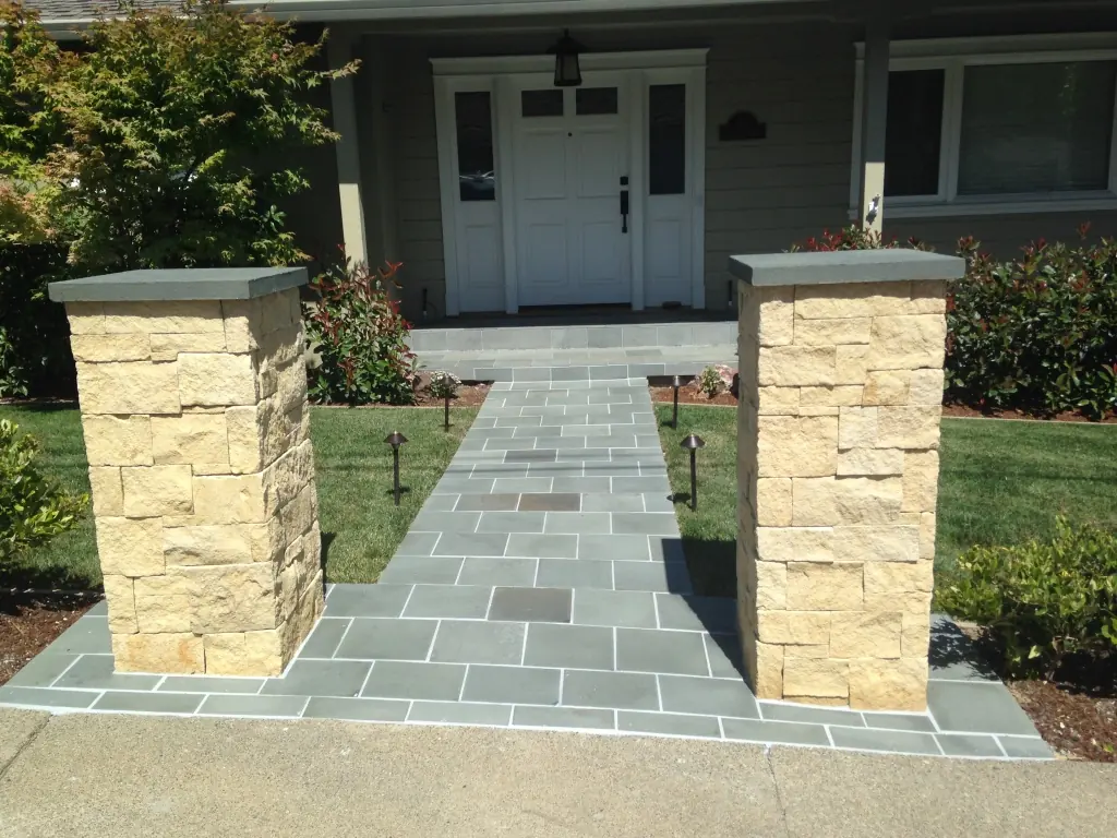 Stone entry pillars with a flagstone walkway