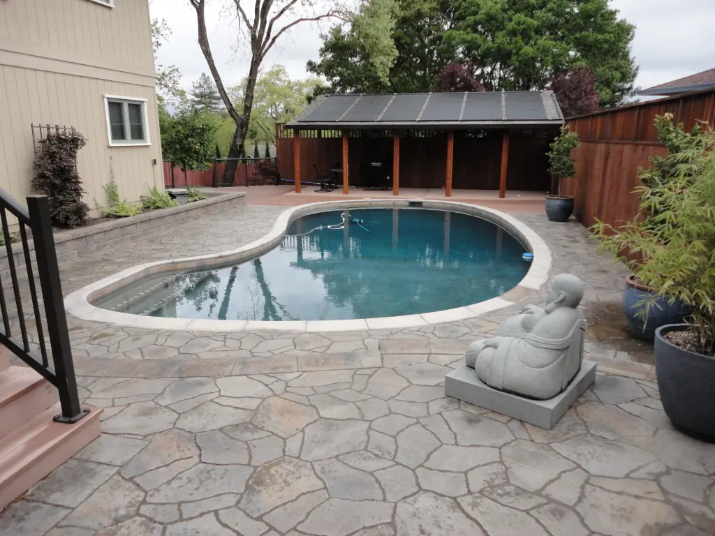 Flagstone patio around a backyard pool