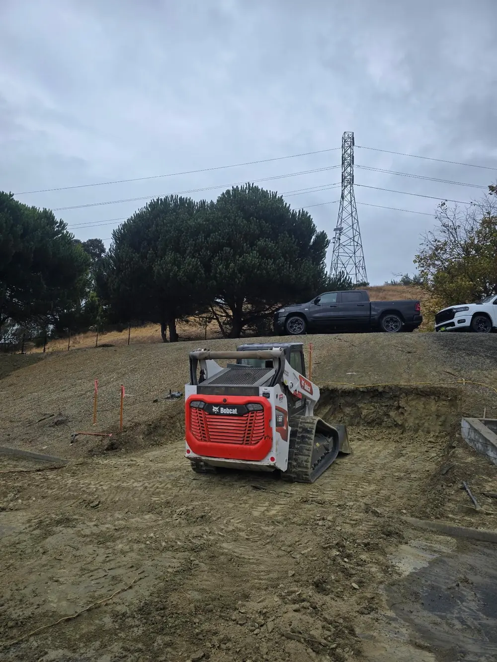 Compact track loader excavating