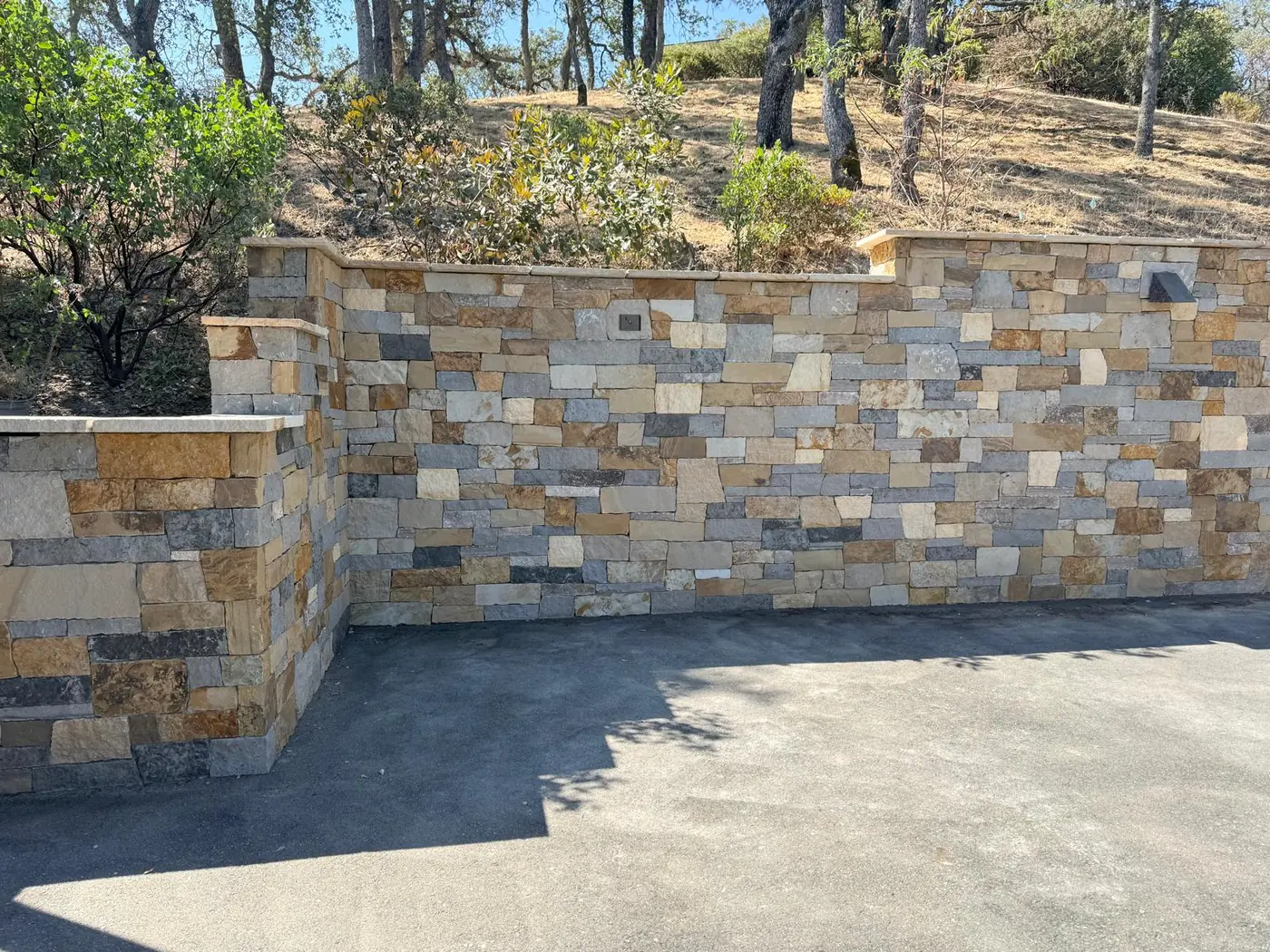 Natural stone retaining wall with planters